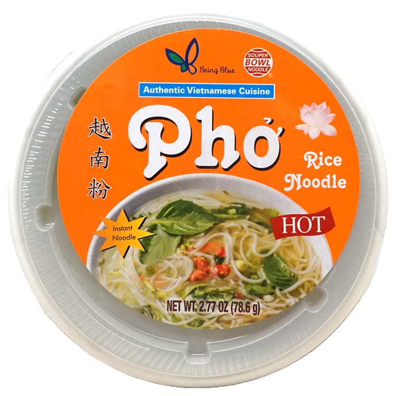 Top view of package. The image shows a bowl of pho with thin rice noodles in a clear broth. Fresh green herbs and slices of red chili peppers are visible on top, giving it a vibrant and appetizing look.